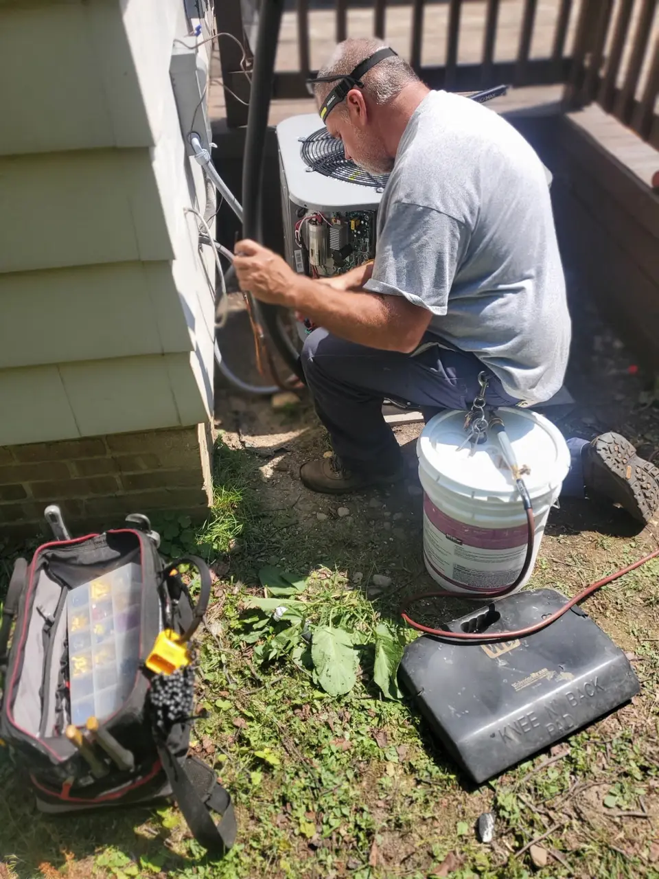 Technician wiring the disconnect on a newly set condenser at a Cleveland-area home