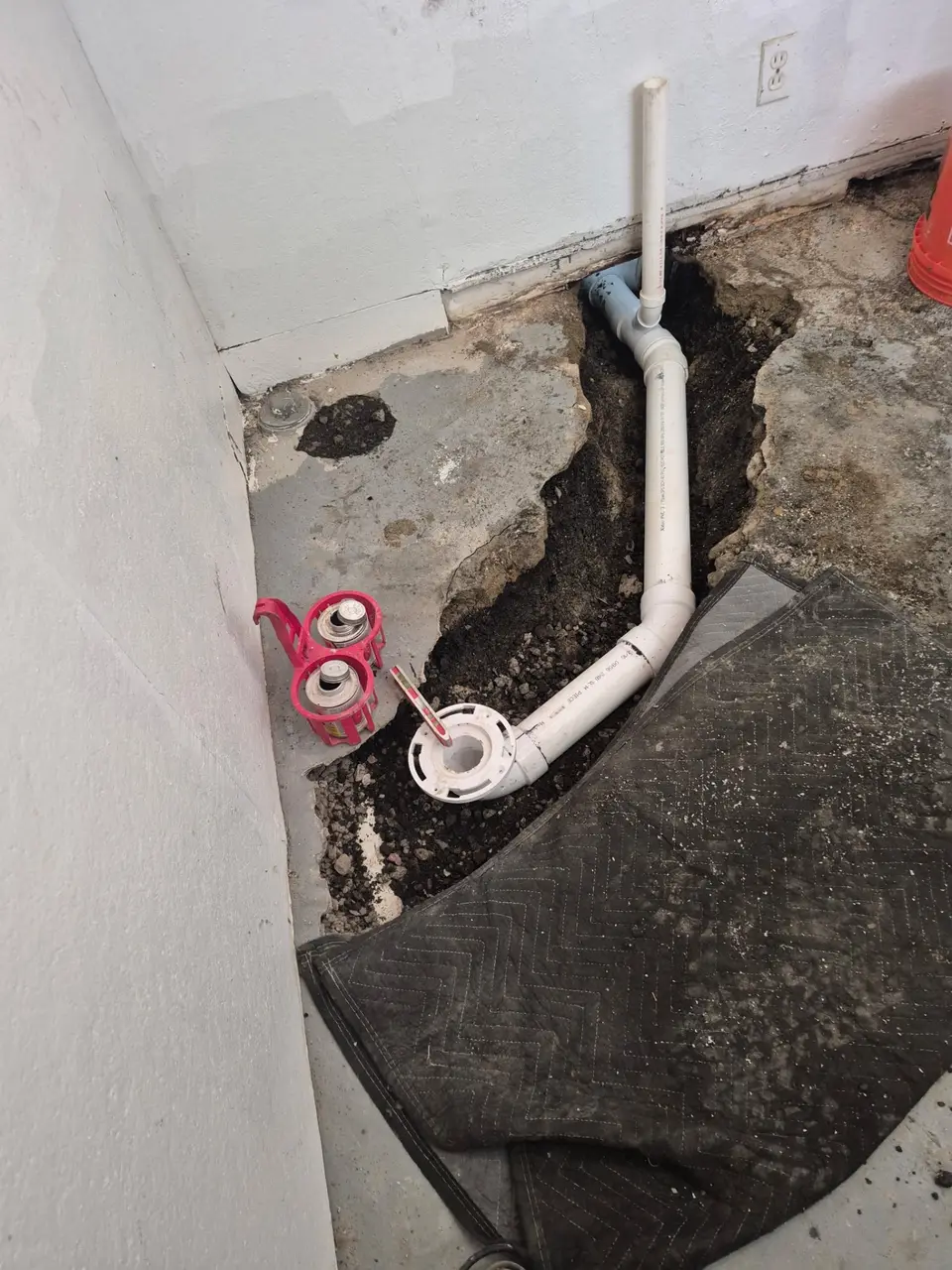 New PVC drain line set in an opened basement floor during a sewer repair in Brunswick, OH