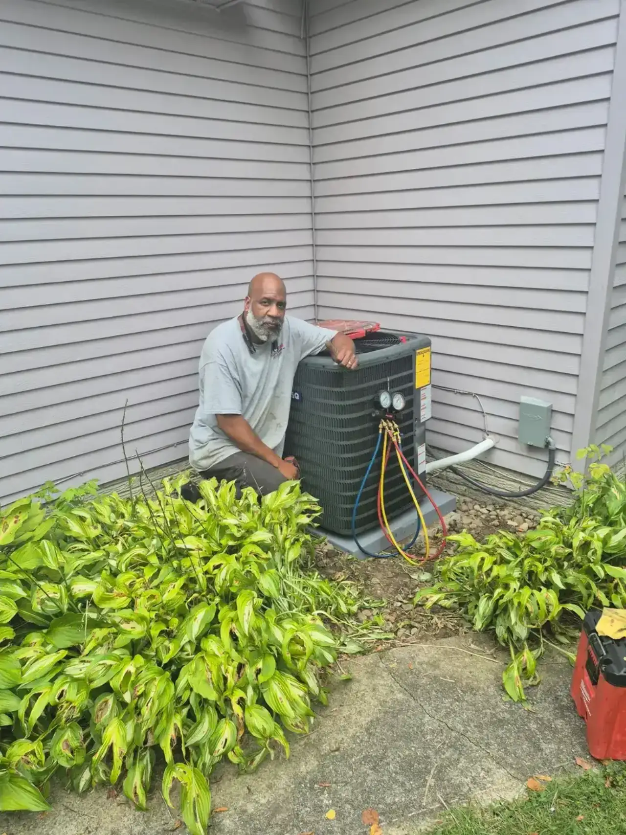 All-Pro technician charging an outdoor air conditioning condenser at a Brunswick, OH home
